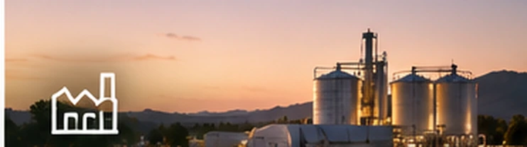 Industrial processing towers and storage silos at sunset